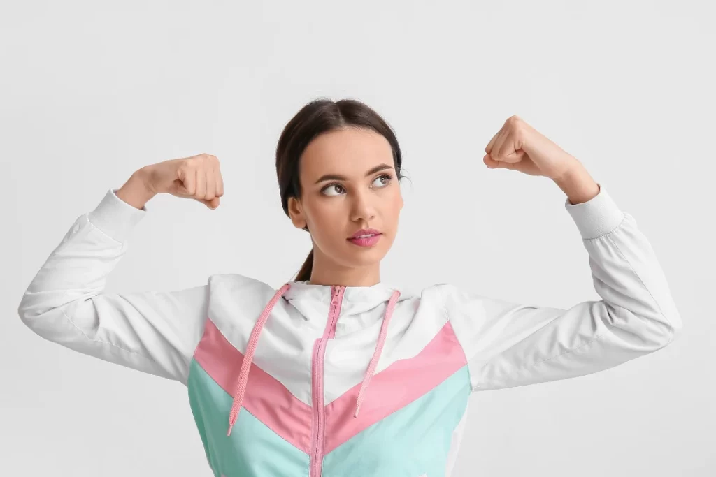 Strong Young Woman on Light Background. Immunity Concept