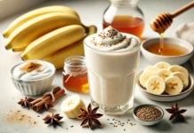 A light beige anise and banana smoothie in a clear glass, surrounded by fresh banana slices, anise seeds, Greek yogurt, honey, and cinnamon on a bright kitchen counter. A gut-soothing drink designed to relax intestinal muscles and relieve cramping.