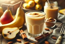 A creamy banana-pear sleep smoothie in a clear glass, surrounded by fresh pears, a ripe banana, cinnamon sticks, and almond butter. The smoothie has a smooth, light golden color with a velvety texture, set in a softly lit, cozy background for a sleep-inducing ambiance.