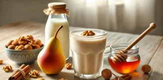 A creamy smoothie in a clear glass, surrounded by a ripe pear, walnuts, cinnamon sticks, honey, and almond milk on a sunlit wooden kitchen surface—perfectly styled to reflect a brain-boosting, nutty blend for cognitive support.